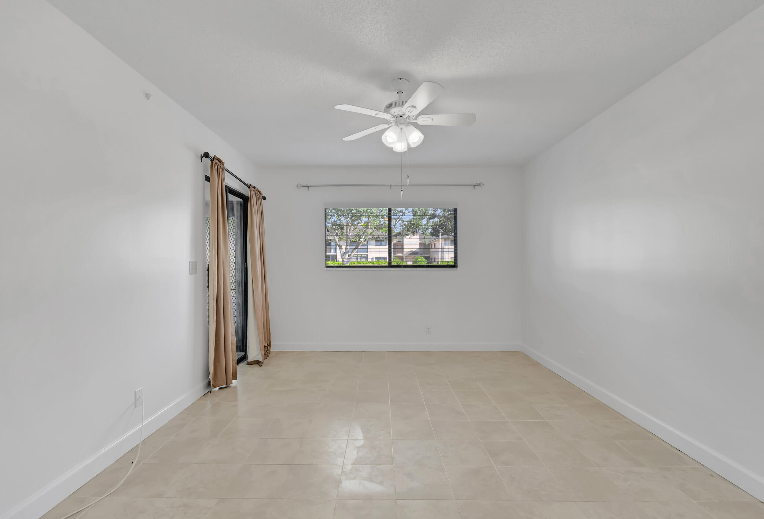 15364 Lakes Of Delray Boulevard, Unit 45 Delray Beach, FL 33484 - Photo 30 of 56 an empty room with a window and a ceiling fan