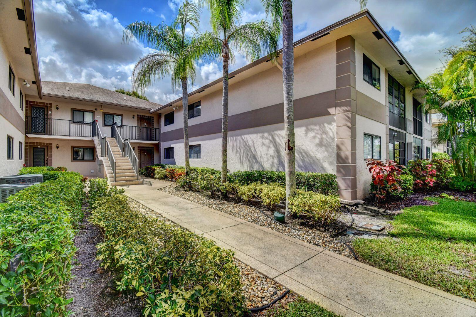 15364 Lakes Of Delray Boulevard, Unit 45 Delray Beach, FL 33484 - Photo 3 of 56 a front view of a house with a garden