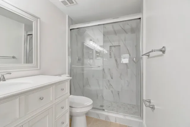 a bathroom with a sink toilet and shower
