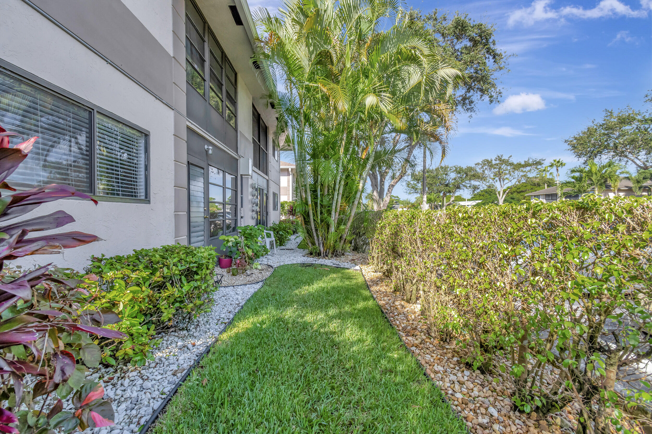 15364 Lakes Of Delray Boulevard, Unit 45 Delray Beach, FL 33484 - Photo 49 of 56 a view of a yard with plants and large trees
