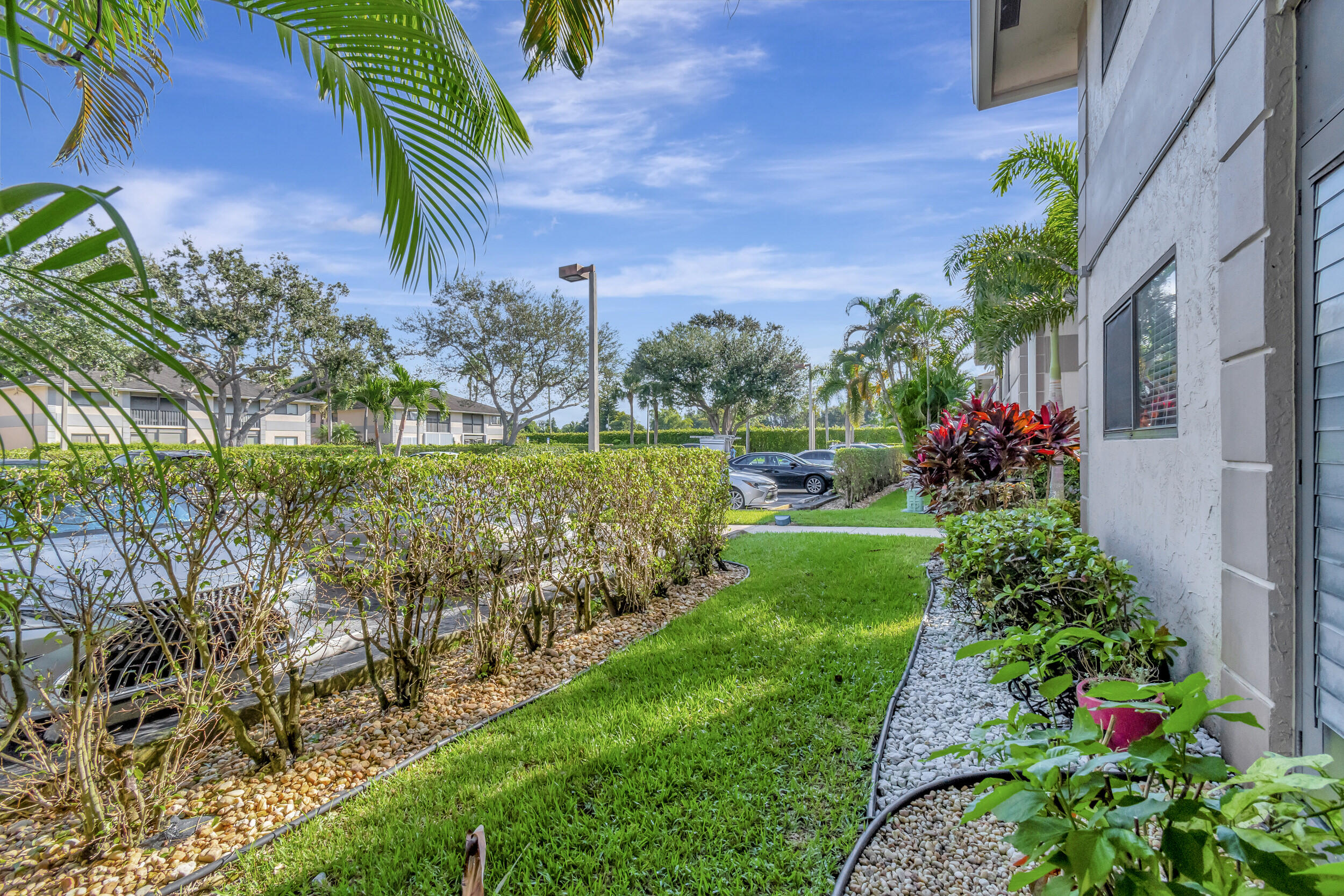 15364 Lakes Of Delray Boulevard, Unit 45 Delray Beach, FL 33484 - Photo 51 of 56 a front view of a house with a yard