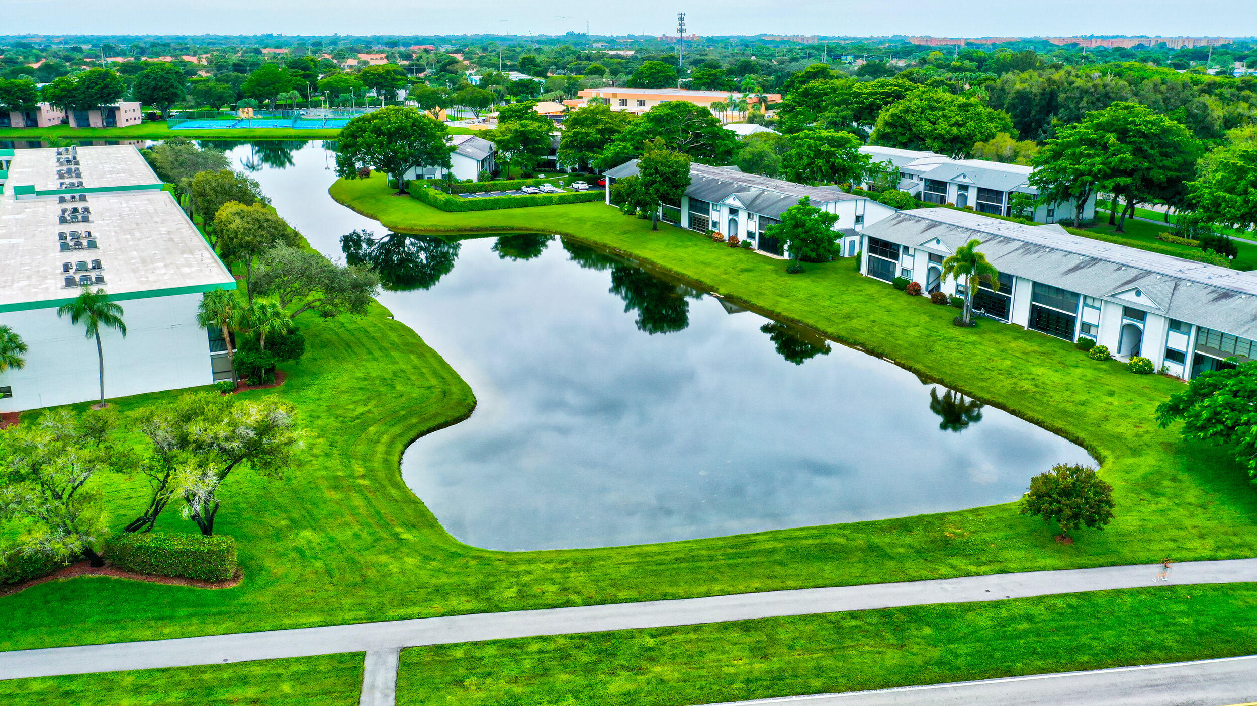 15364 Lakes Of Delray Boulevard, Unit 45 Delray Beach, FL 33484 - Photo 55 of 56 a view of a garden with plants and lake view
