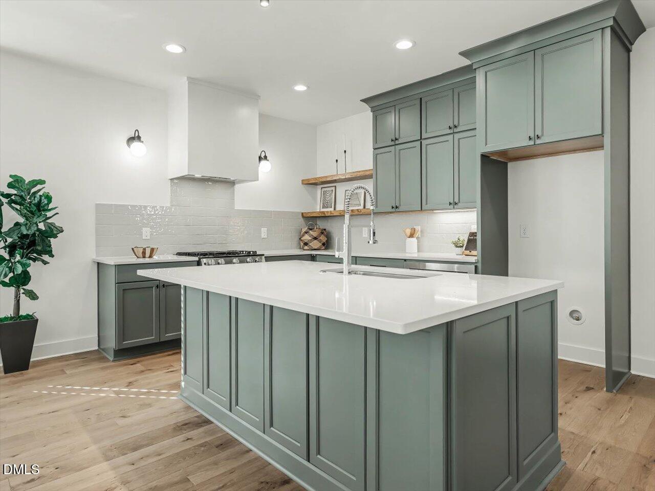 2312 Broad Street Durham, NC 27704 - Photo 9 of 53 a kitchen with kitchen island granite countertop a sink stove and refrigerator