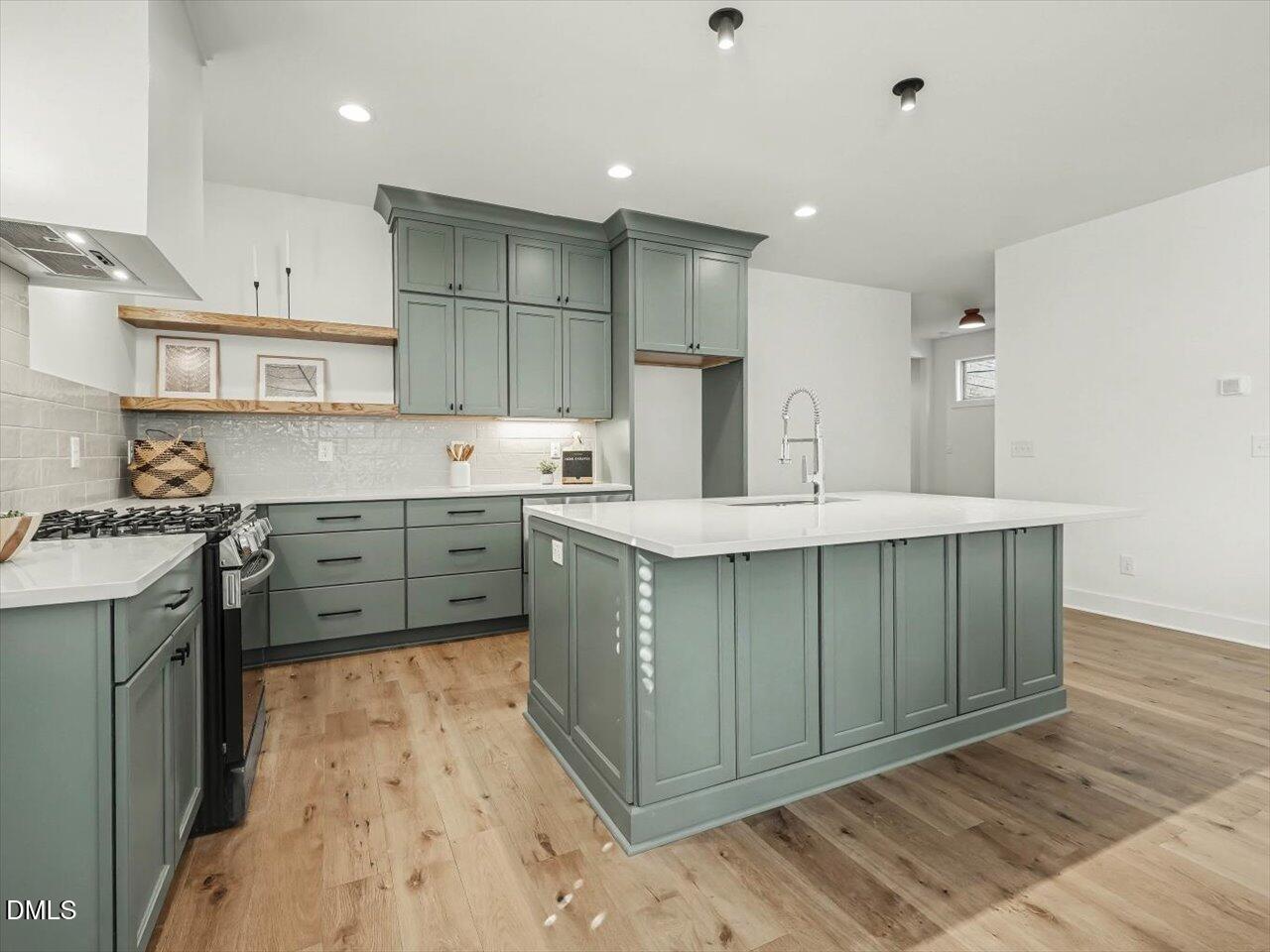 2312 Broad Street Durham, NC 27704 - Photo 10 of 53 a kitchen with a sink cabinets and wooden floor