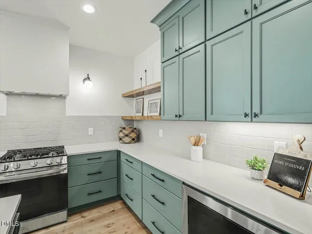 a kitchen with kitchen island a sink stove and refrigerator