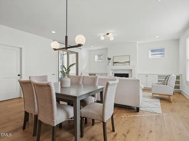 a kitchen with kitchen island a sink table and chairs