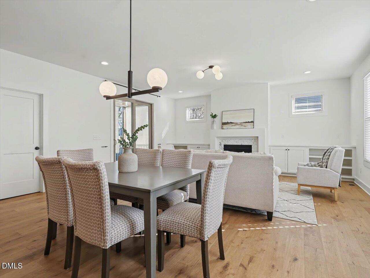 2312 Broad Street Durham, NC 27704 - Photo 18 of 53 a living room with furniture kitchen view and a chandelier