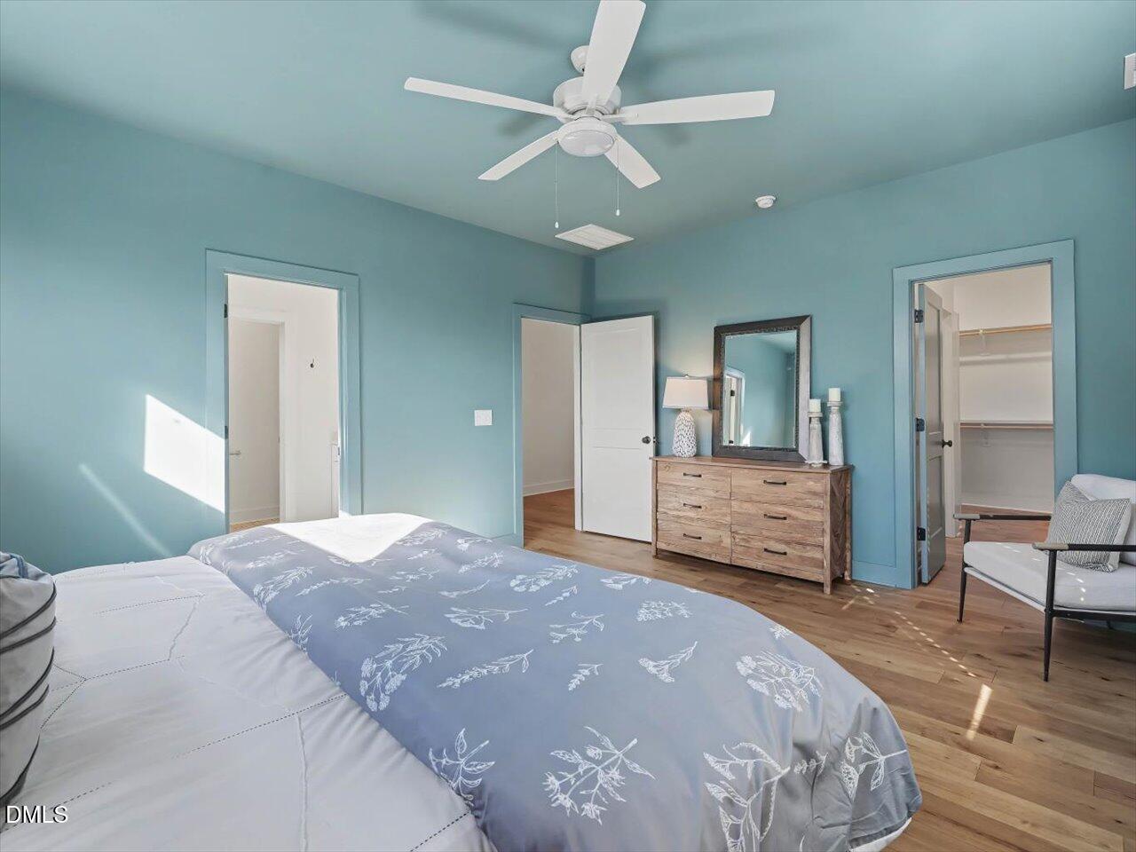 2312 Broad Street Durham, NC 27704 - Photo 30 of 53 a bedroom with a large bed and a chandelier