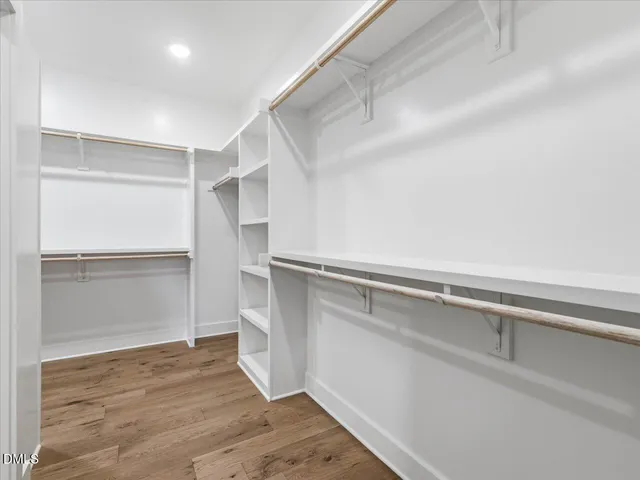 a view of walk in closet with empty racks