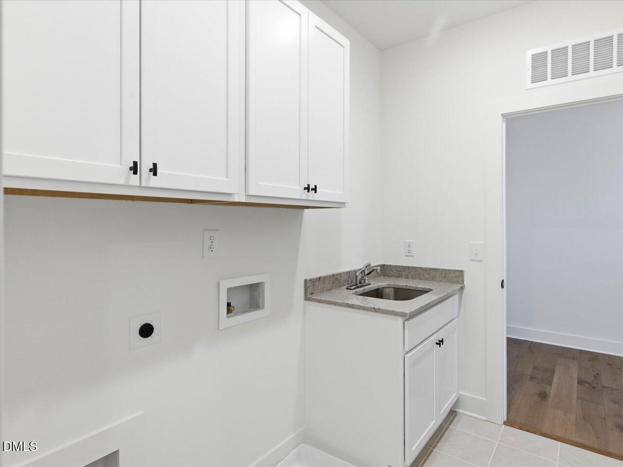 2312 Broad Street Durham, NC 27704 - Photo 37 of 53 a kitchen with a sink and cabinets