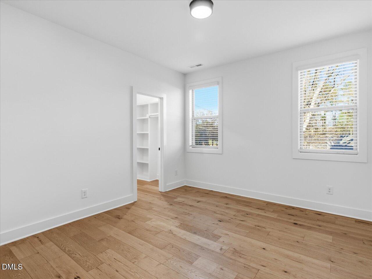 2312 Broad Street Durham, NC 27704 - Photo 41 of 53 an empty room with wooden floor and windows