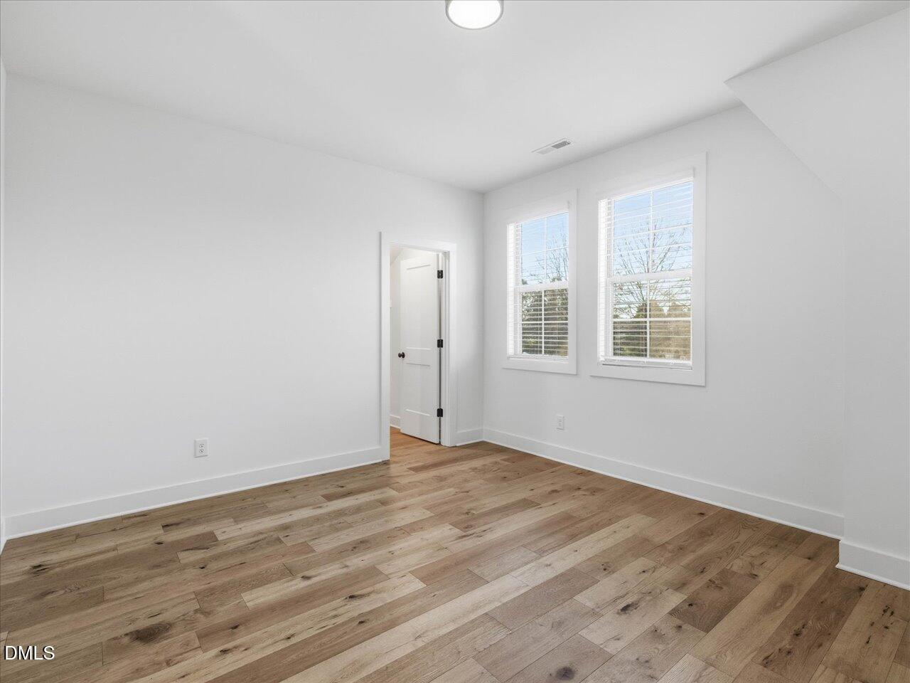 2312 Broad Street Durham, NC 27704 - Photo 45 of 53 a view of an empty room with wooden floor and a window