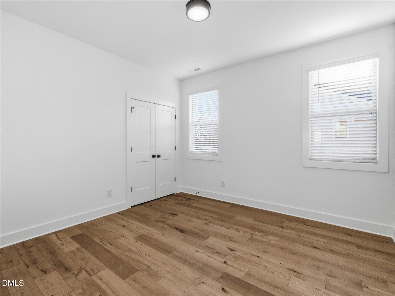2312 Broad Street Durham, NC 27704 - Photo 50 of 53 an empty room with wooden floor and windows