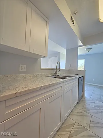 a kitchen with sink and cabinets