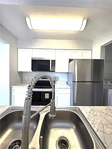 a kitchen with a refrigerator and a stove