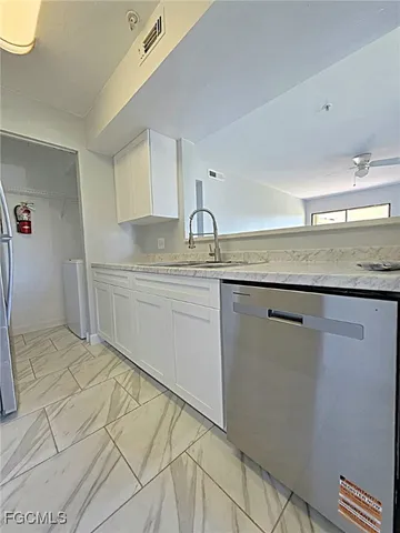 a kitchen with stainless steel appliances granite countertop a sink and cabinets