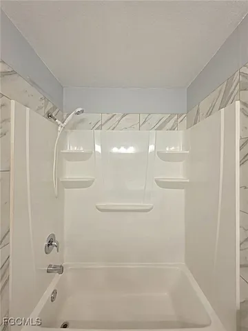 a bathroom with a shower and a bath tub