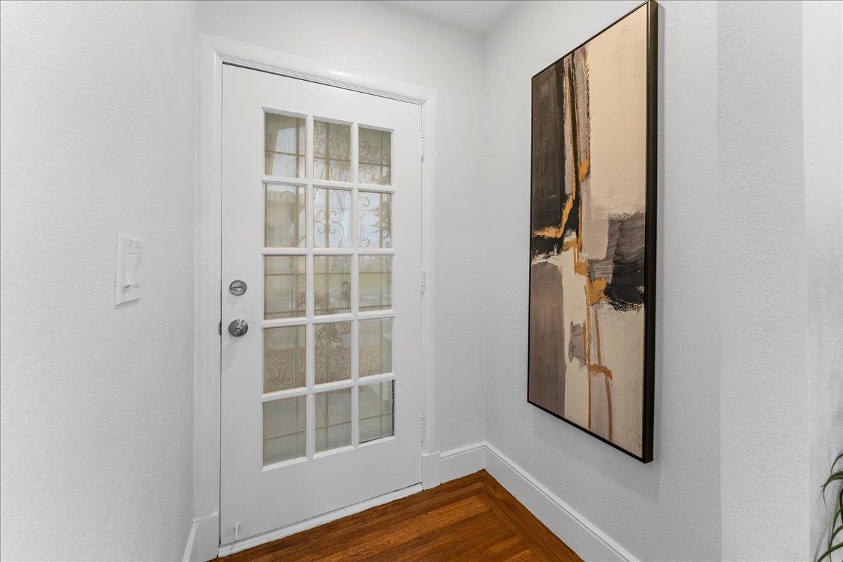 2717 Mabel Street Berkeley, CA 94702 - Photo 27 of 59 Doorway to outside featuring wood finished floors and a textured wall