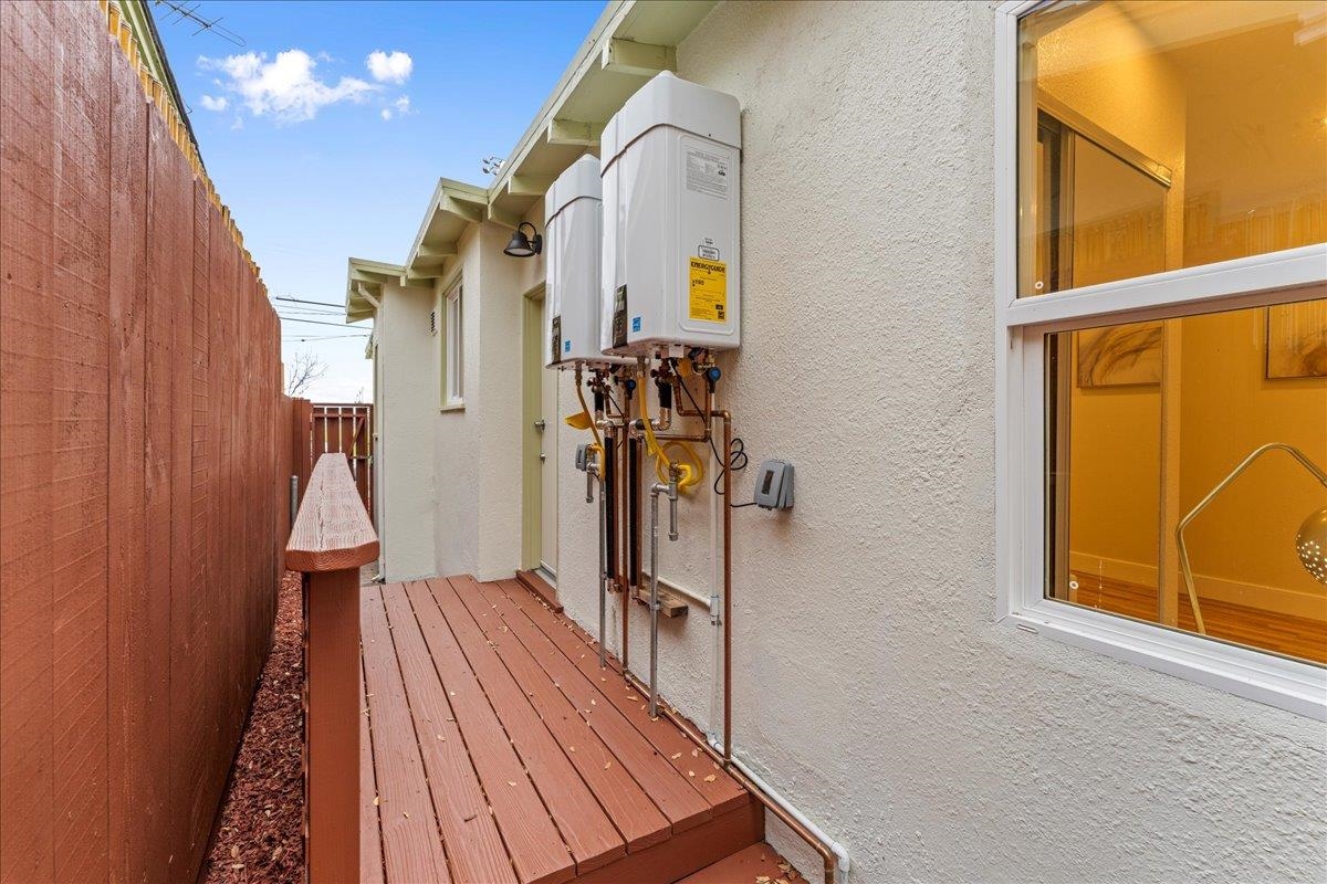 2717 Mabel Street Berkeley, CA 94702 - Photo 48 of 59 View of home's exterior featuring stucco siding, a wooden deck, and water heater