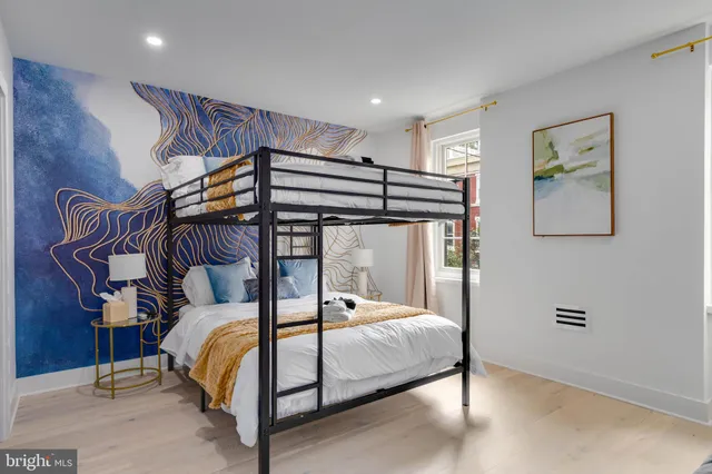 a bedroom with a bed and glass walk in closet