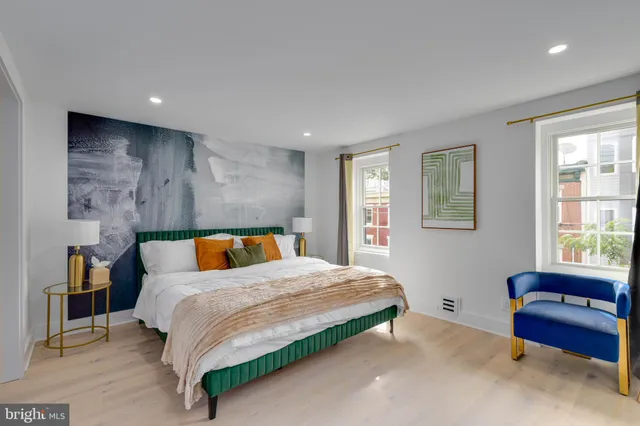 a bedroom with a bed and a couch