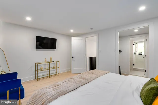 a bedroom with a bed and a flat screen tv