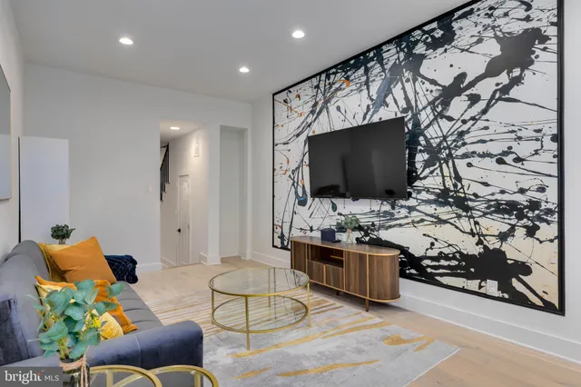 a living room with furniture and a flat screen tv