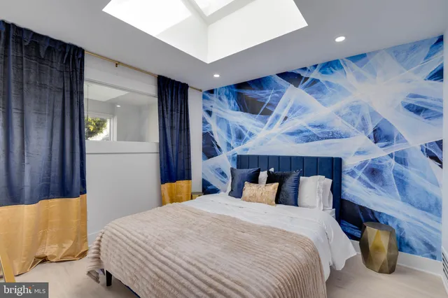 a bedroom with a bed and a mirror