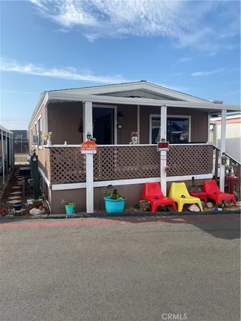 a view of house with swimming pool and porch
