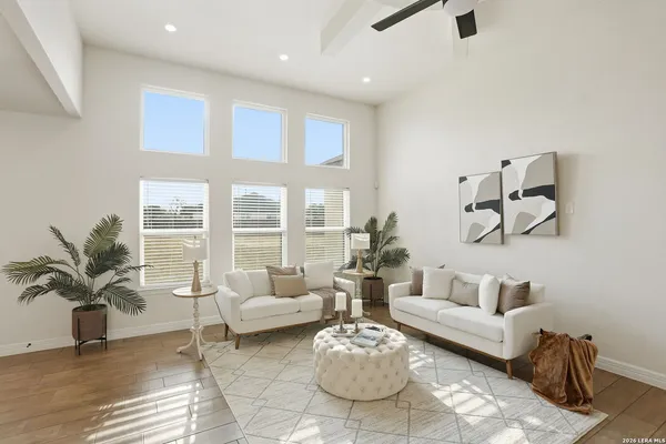 a living room with furniture and wooden floor