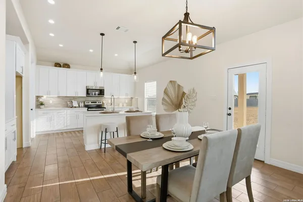 a kitchen with kitchen island granite countertop a sink a counter space appliances and cabinets