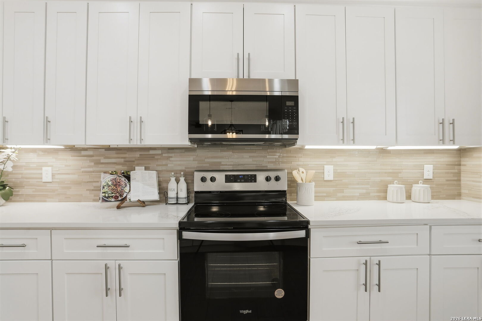 100 West Short Meadow Drive Lytle, TX 78052 - Photo 23 of 51 a kitchen with granite countertop white cabinets and stainless steel appliances