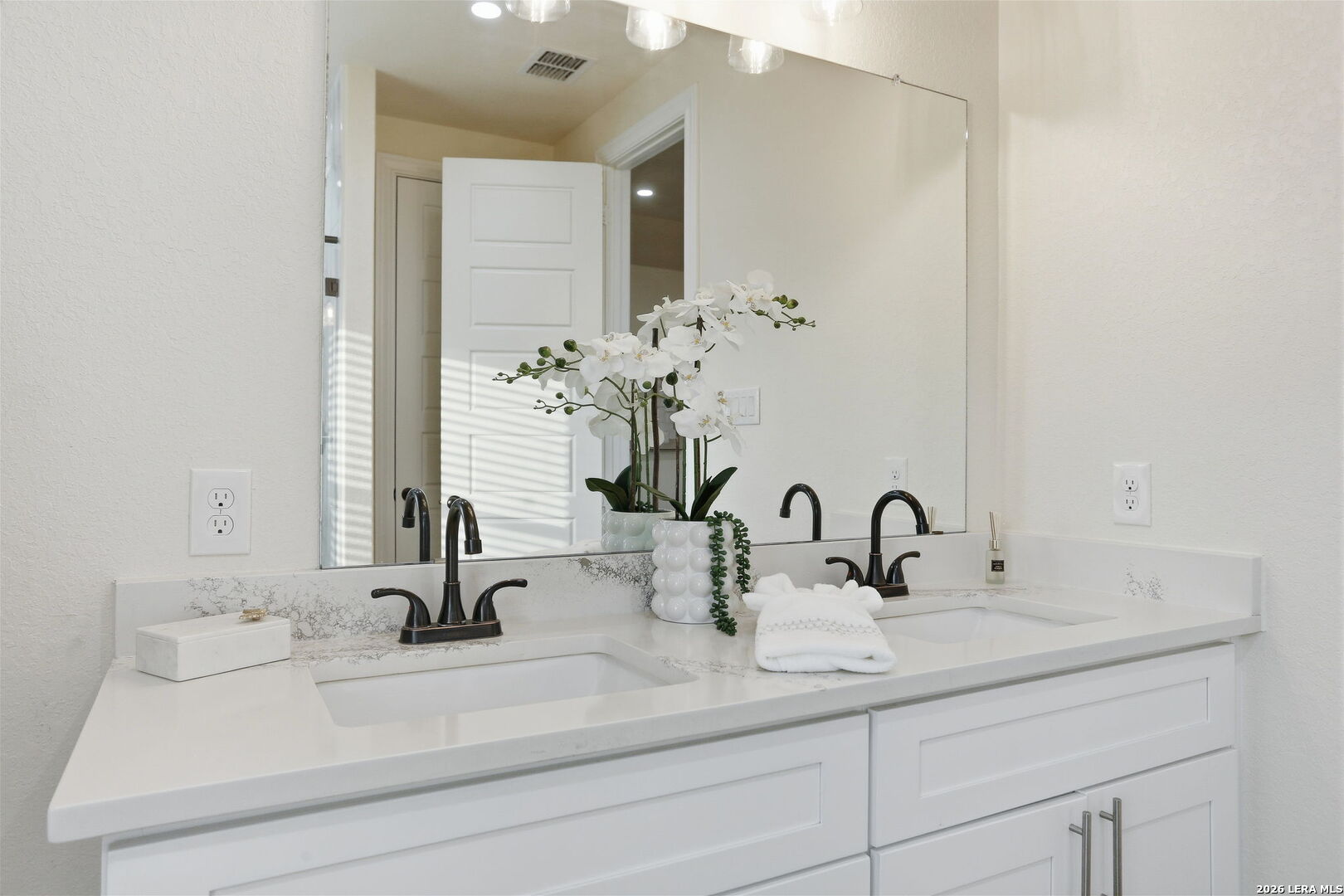 100 West Short Meadow Drive Lytle, TX 78052 - Photo 29 of 51 a bathroom with double vanity sinks and a mirror