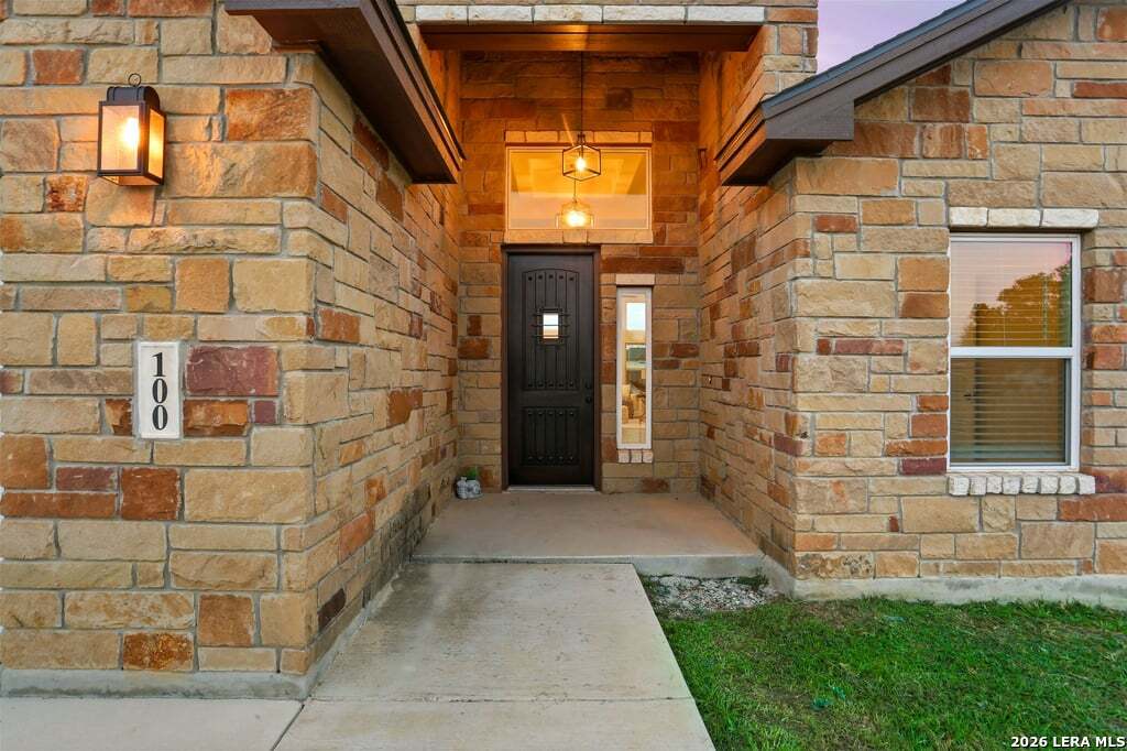 100 West Short Meadow Drive Lytle, TX 78052 - Photo 3 of 51 a view of a brick house with a yard