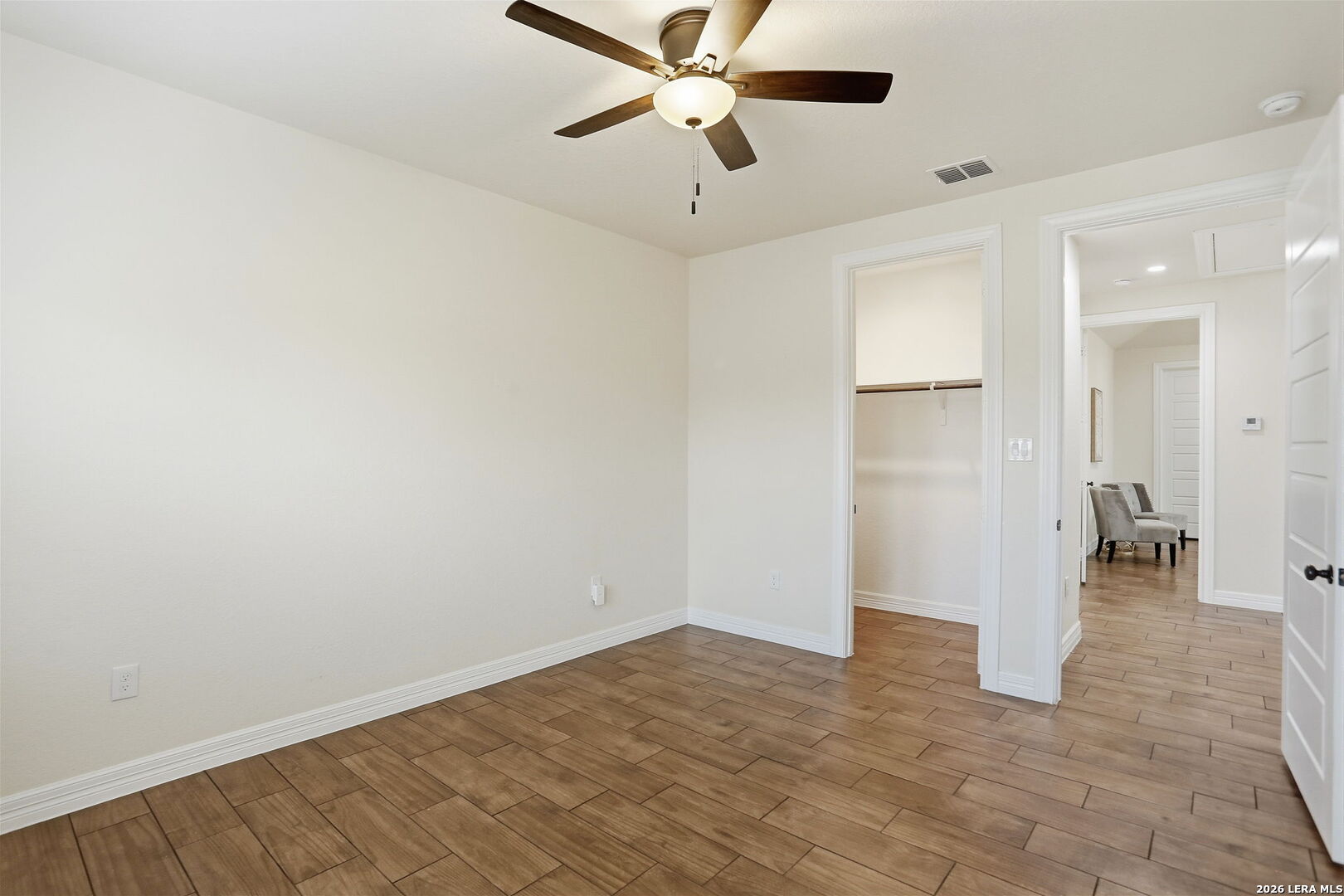 100 West Short Meadow Drive Lytle, TX 78052 - Photo 33 of 51 a view of empty room with wooden floor and ceiling fan