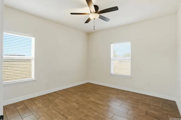 a view of an empty room and wooden floor
