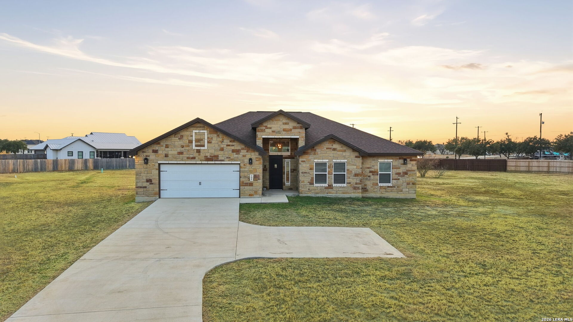 100 West Short Meadow Drive Lytle, TX 78052 - Photo 4 of 51 a front view of a house with a yard and lake view