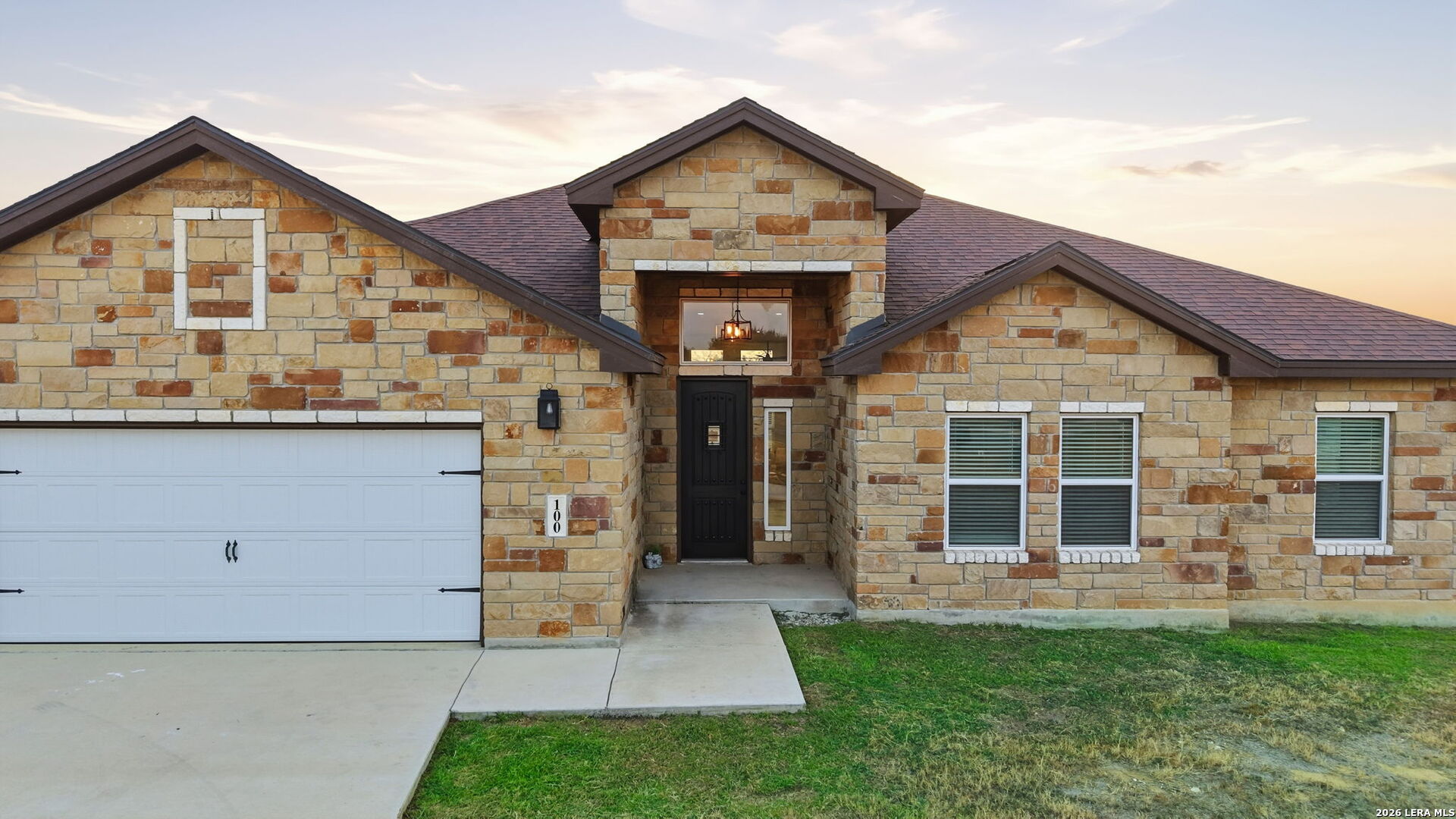 100 West Short Meadow Drive Lytle, TX 78052 - Photo 6 of 51 a front view of a house with a garden