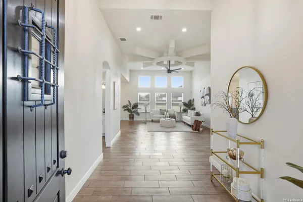 a view of an entryway with wooden floor and a livingroom view