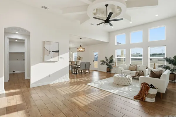 a living room with furniture and a chandelier