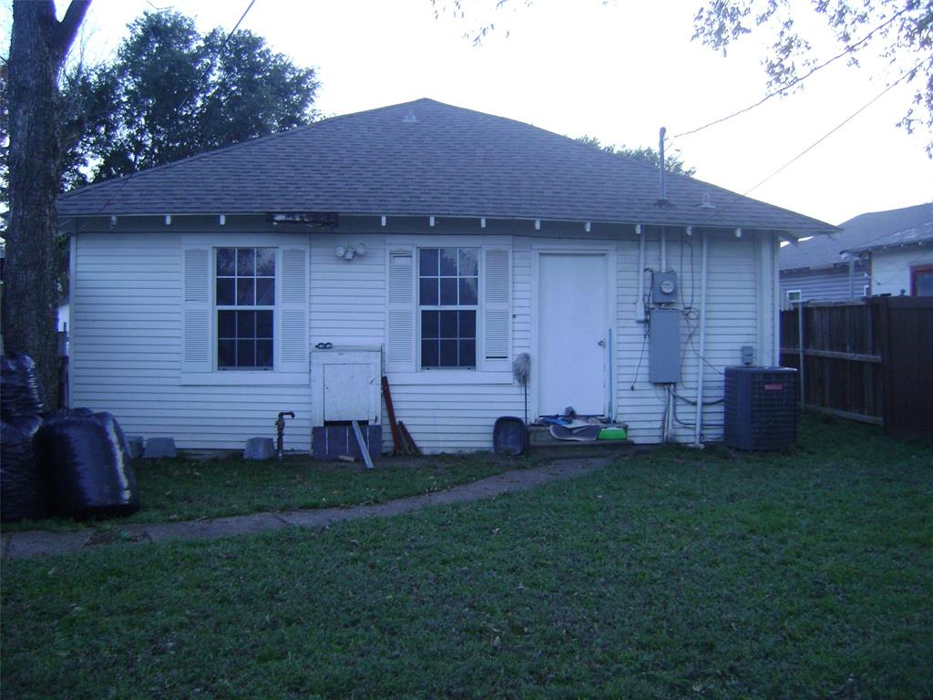2419 Catherine Street Dallas, TX 75211 - Photo 4 of 12 a view of a backyard with potted plants and a large tree