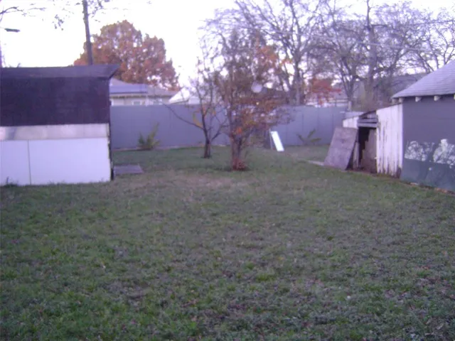 a backyard of a house with lots of green space and street view