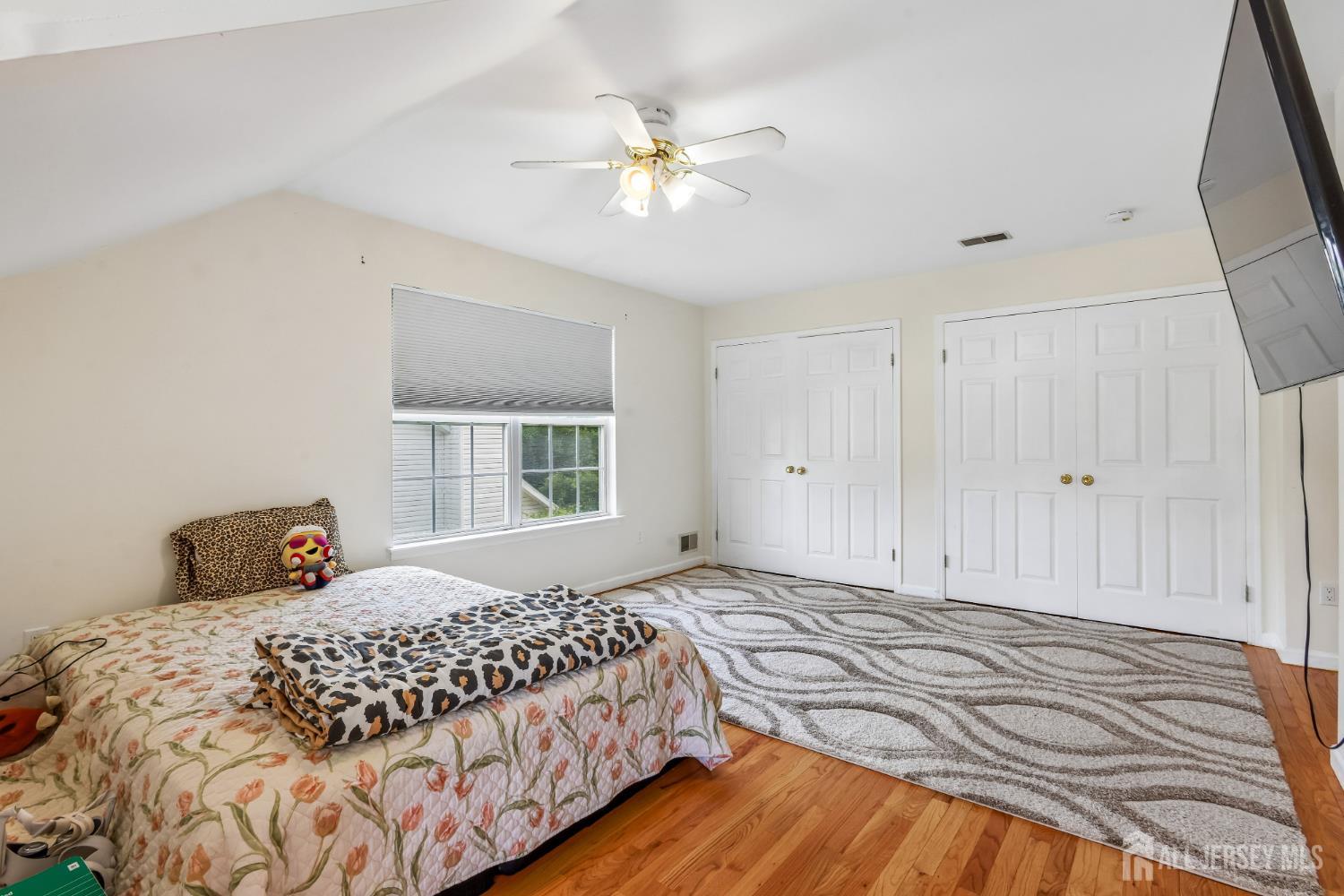 489 Plainfield Road Edison, NJ 08820 - Photo 15 of 39 a bedroom with a large bed and a window