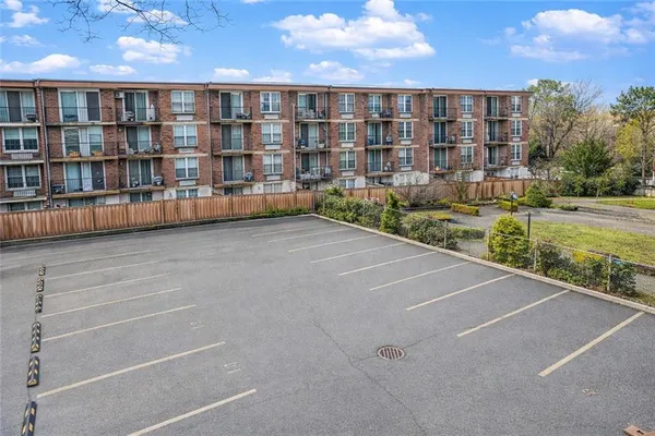 a view of an apartment with a garden and trees