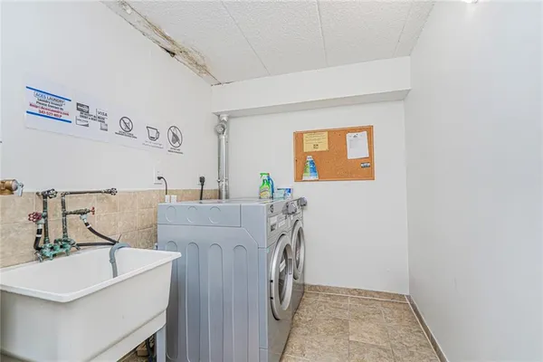 a utility room with cabinets washer and dryer