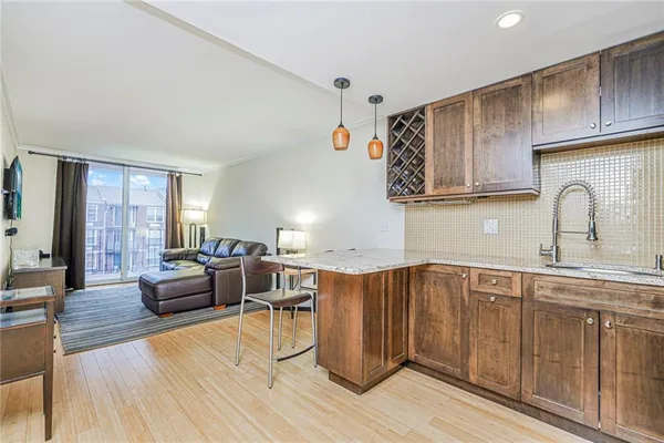 a kitchen with a sink cabinets and wooden floor