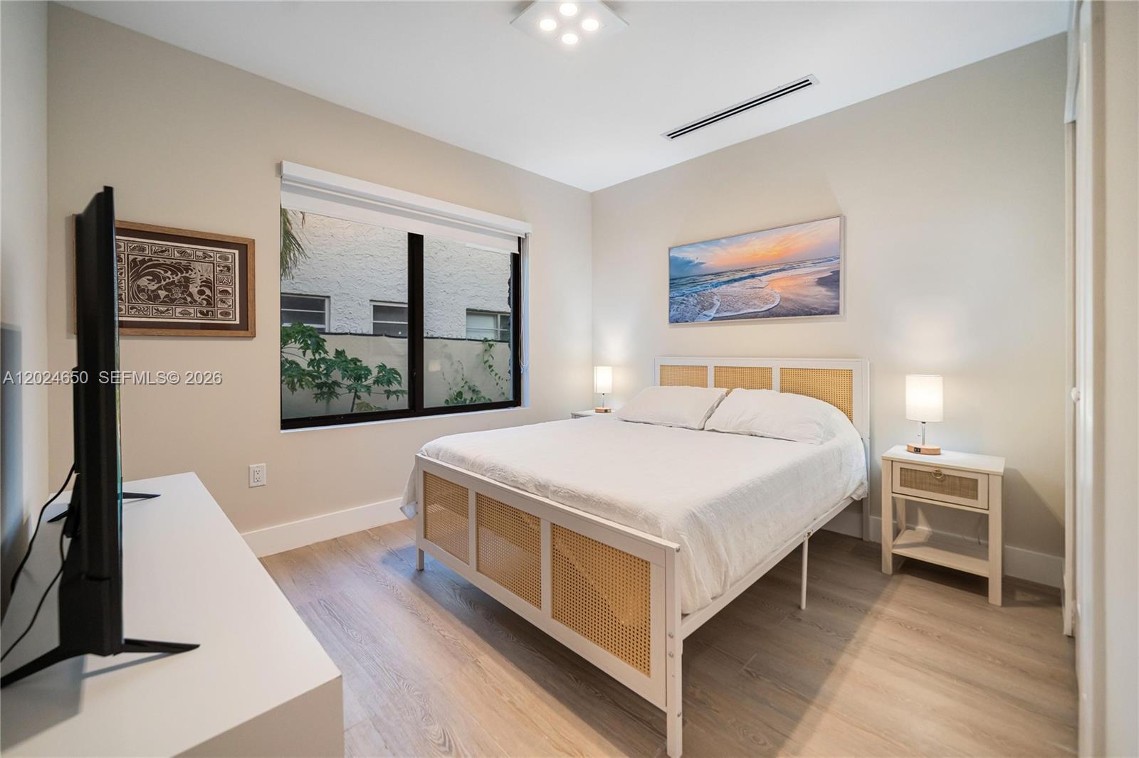 1663 Southwest 13th Street Miami, FL 33145 - Photo 38 of 112 a bedroom with a bed and a flat tv screen on dresser