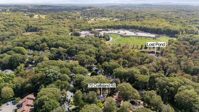 an aerial view of residential building with outdoor space and parking