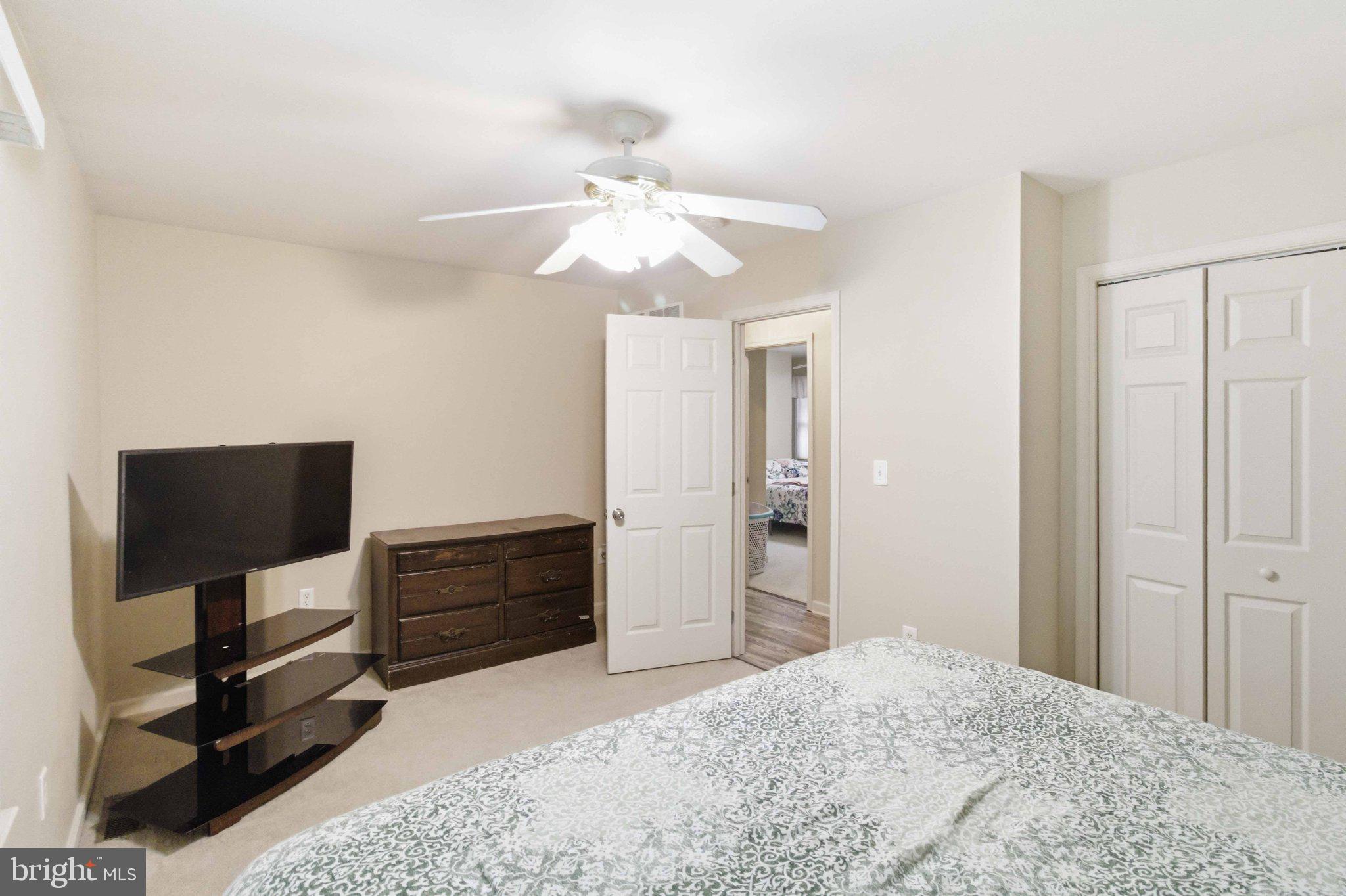 4 Grouse Road Dillsburg, PA 17019 - Photo 22 of 40 a bedroom with a bed and a chandelier
