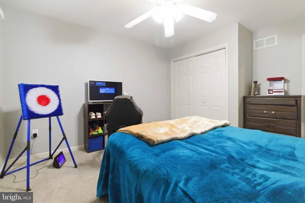 a bedroom with a bed and dresser